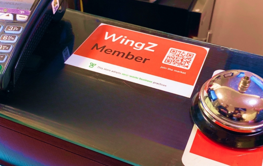 WingZ Member sticker next to a service bell on a counter